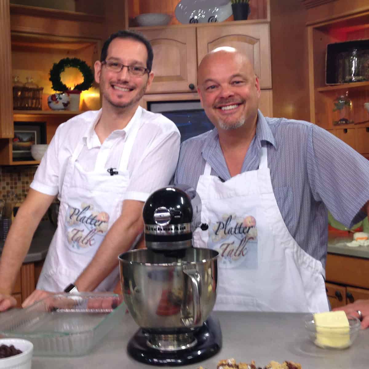 Two handsome men in a kitchen.