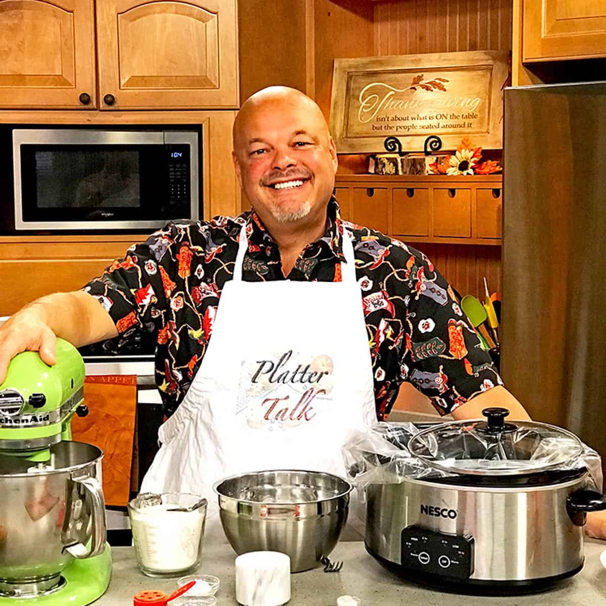 A man standing in a kitchen.